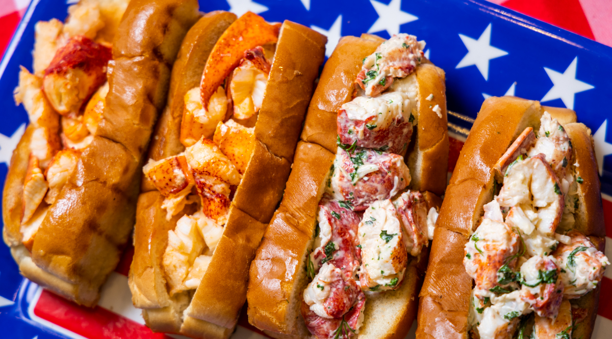 Maine Lobster Rolls and Connecticut Lobster Rolls together on a patriotic tray.